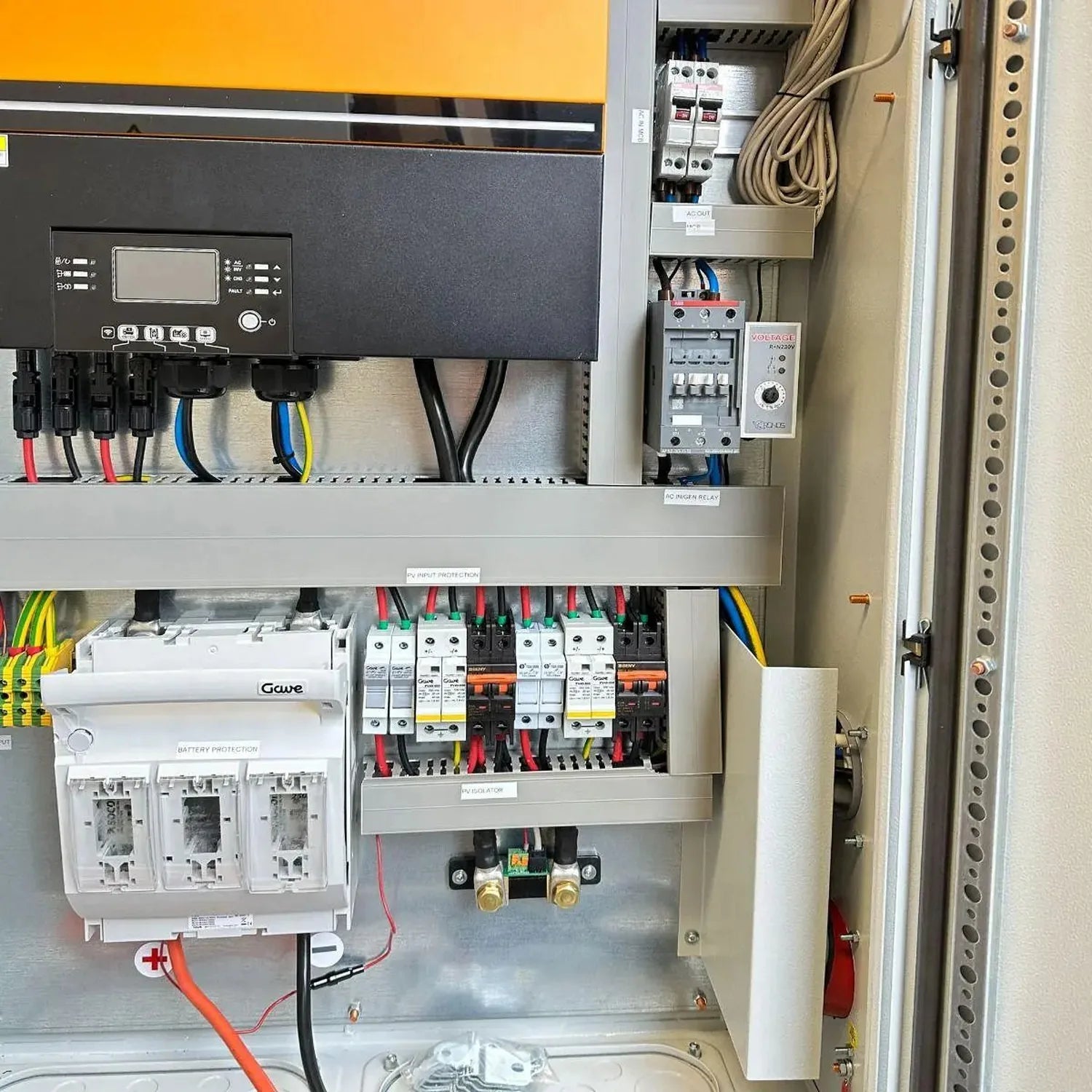 Off-grid solar power cabinet interior showing inverter display, circuit breakers, battery protection module, and wiring insta
