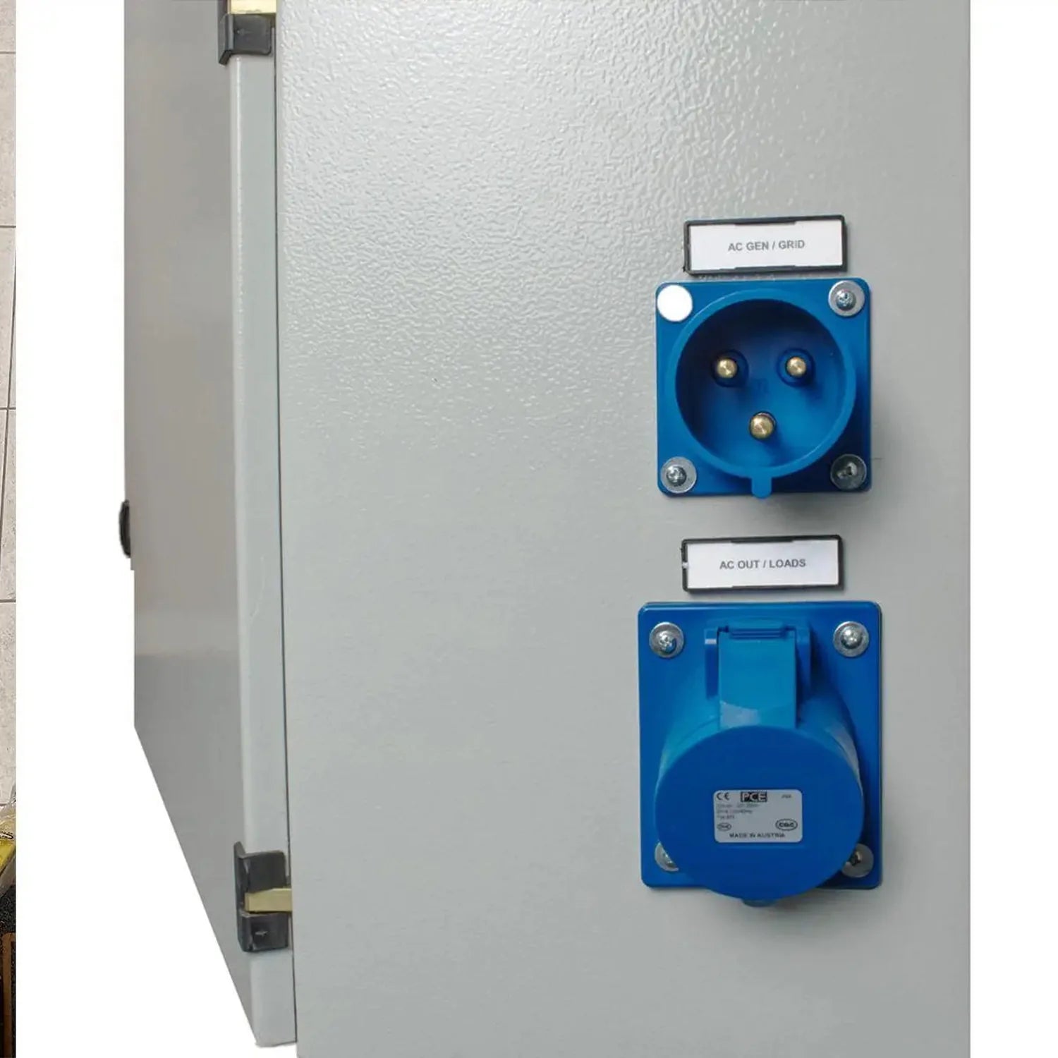 Industrial cabinet showing AC generator/grid inlet socket and AC output/loads socket mounted on white panel, installation sho