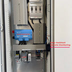 Interior of 33kW floor-mounted power cabinet showing blue Victron inverter, circuit breakers, and wiring with Solar Assistant