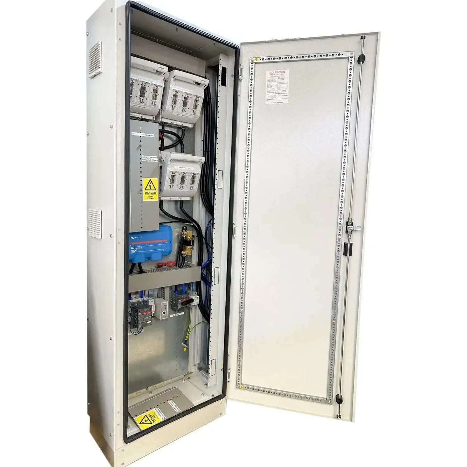 Open electrical cabinet showing internal components including meters, switches, blue battery unit, and wiring with yellow haz