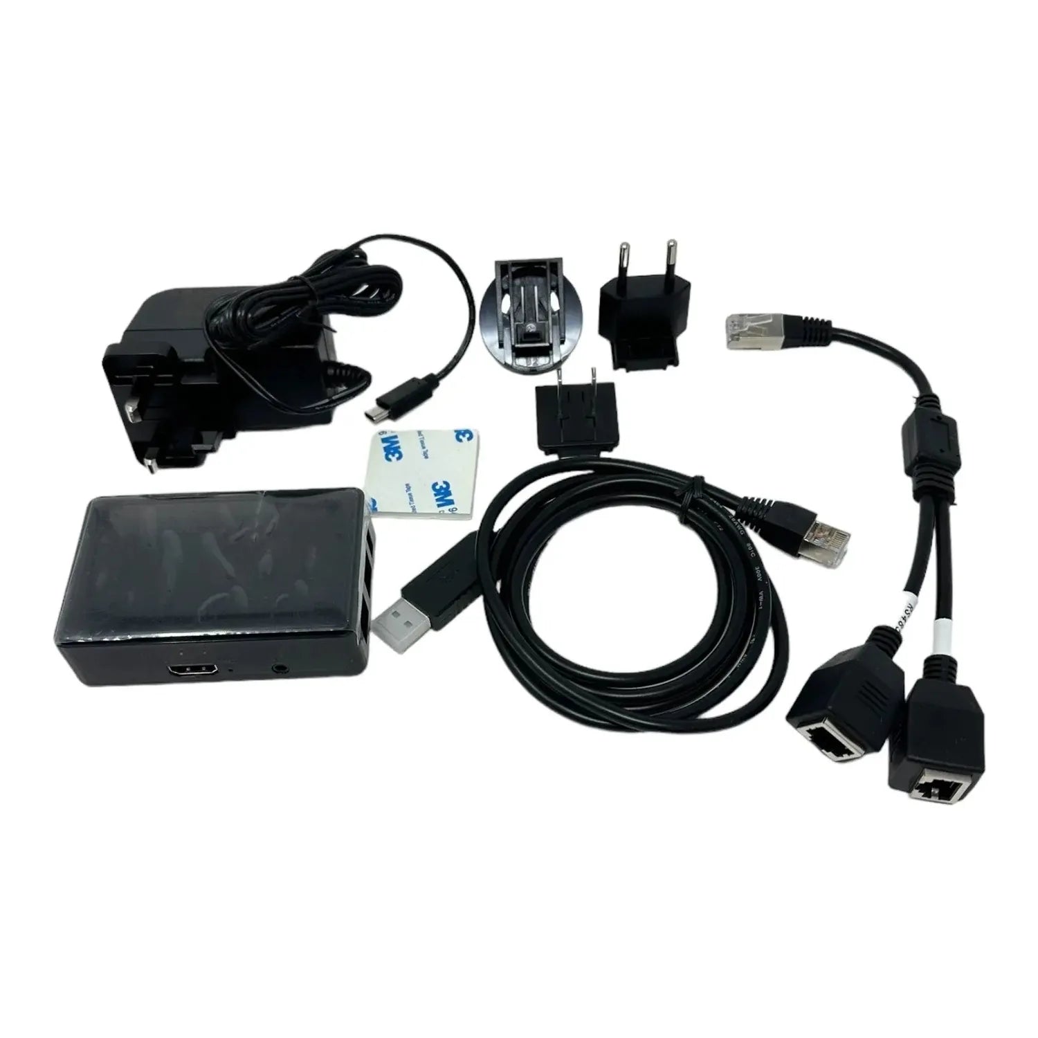Solar Assistant Monitoring Kit components laid out flat: black box unit, power adapter, USB cables, Ethernet cables, wall plu