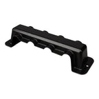 Black metal busbar with four cylindrical poles and protective cover, mounted on white background.